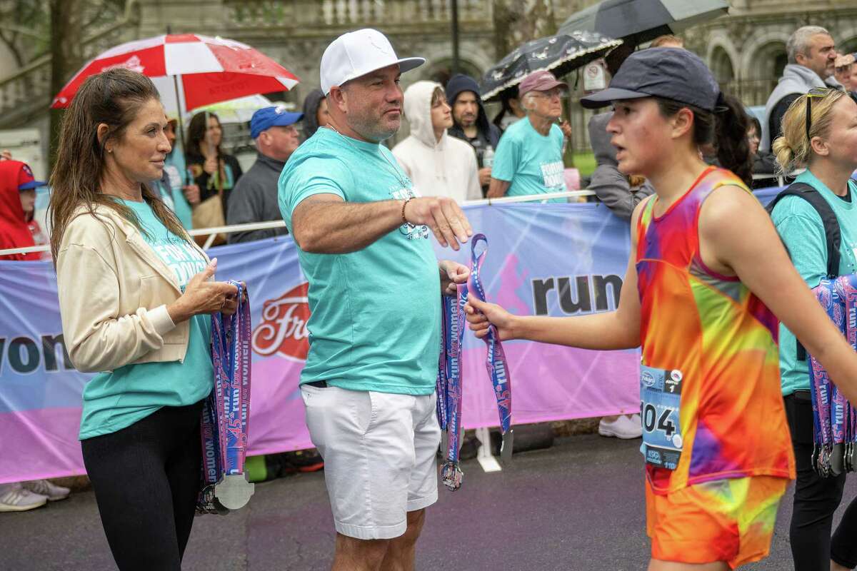 Volunteers hand out medals to runners who finish the 45th Freihofer’s Run for Women on Saturday, June 3, 2023, in Albany, NY.