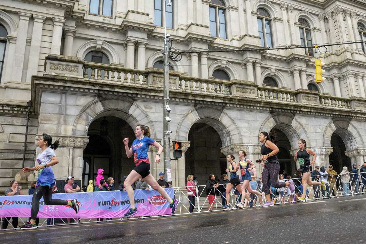 Runners in the 45th Freihofer’s Run for Women pass by the Capitol on Saturday, June 3, 2023, in Albany, NY.