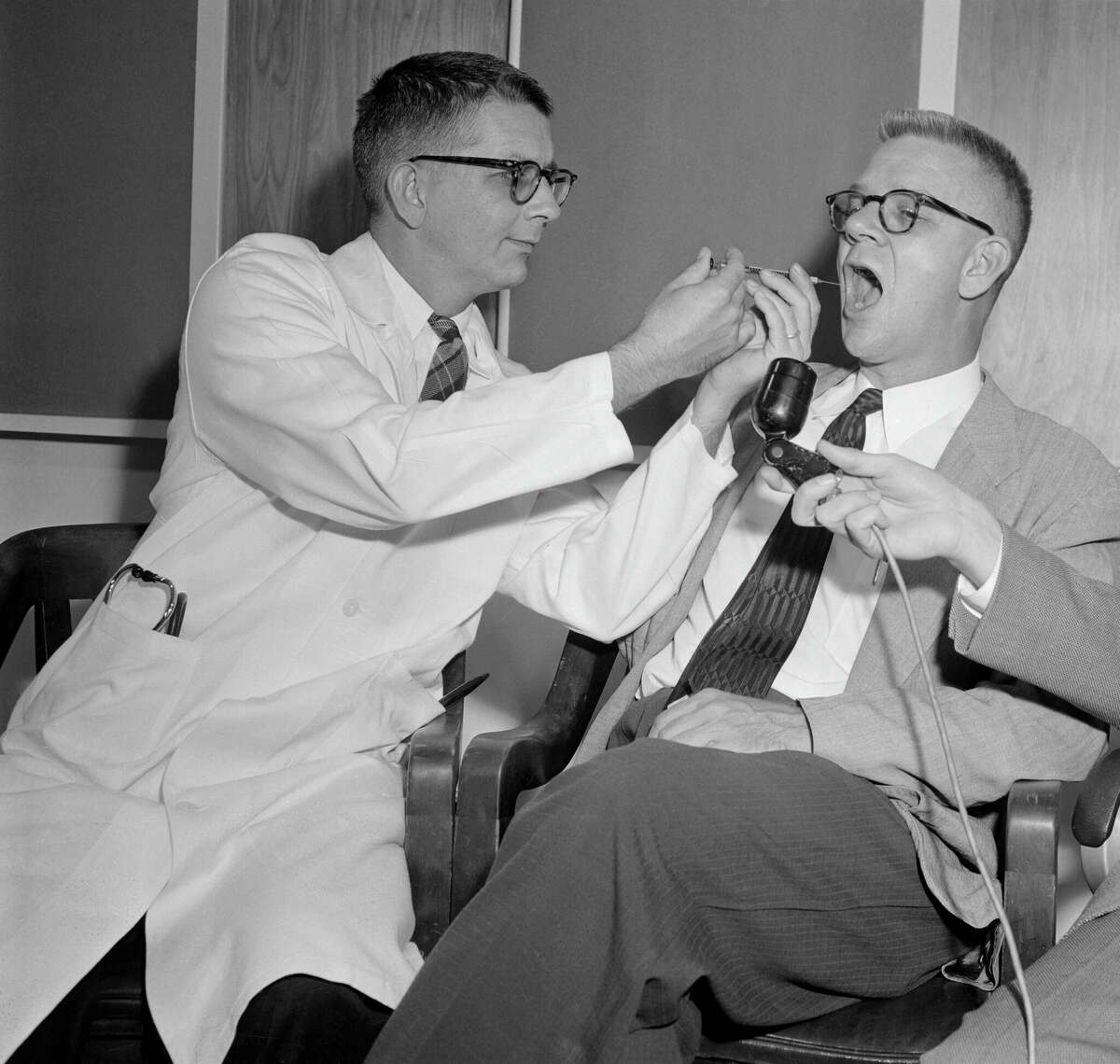 FILE: Dr. Harry L. Williams (left) administers LSD to Dr. Carl Pfeiffer, chairman of Emory University's pharmacological department, in 1955 during early research into the drug.