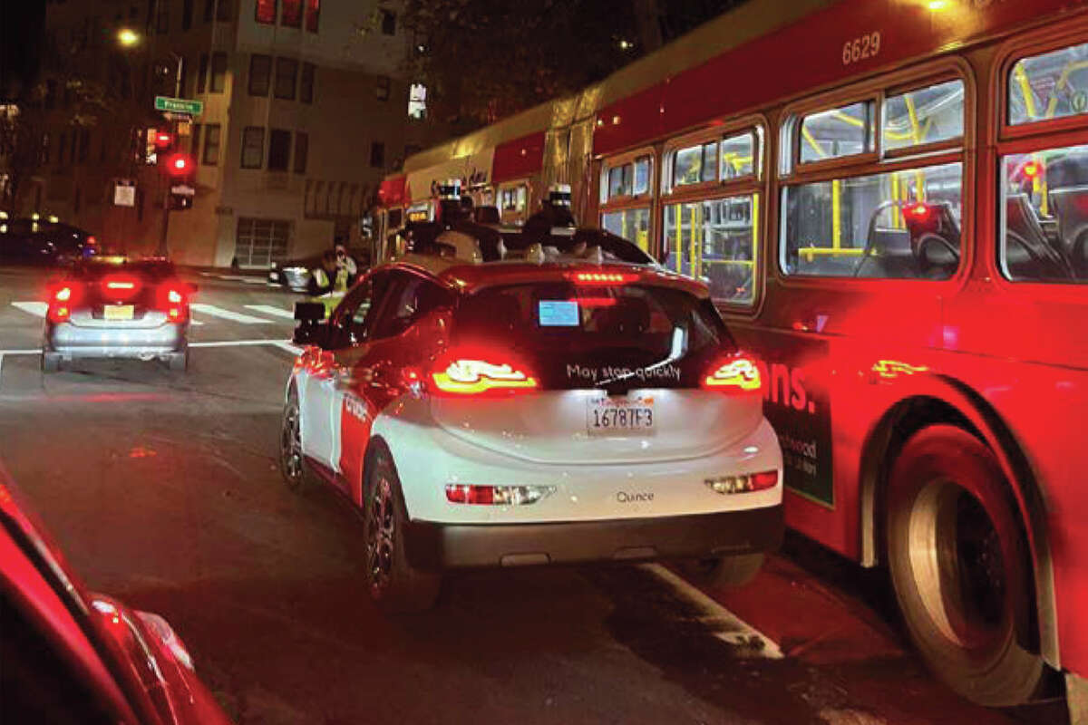 Waymo Taxi drives really close to SF Muni bus in San Francisco Calif.