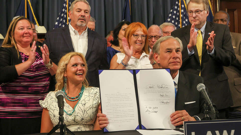 Governor Greg Abbot center, after signing HB:28: The Todd Hogland Act, one of eight bills signed during a public safety bill signing ceremony in his press conference room at the Texas State Capitol on Tuesday, June 6, 2023.