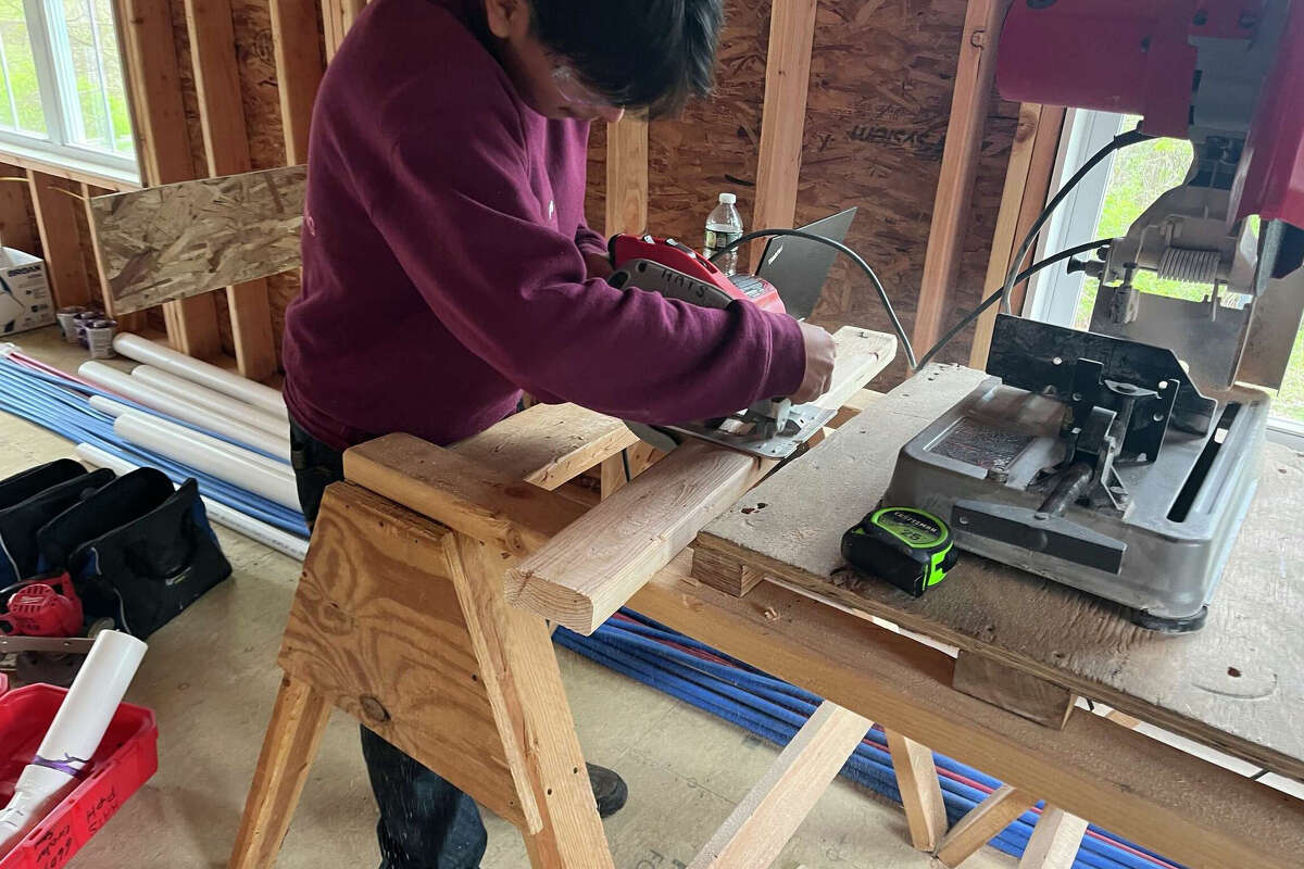 Danbury students install plumbing in Housatonic Habitat home