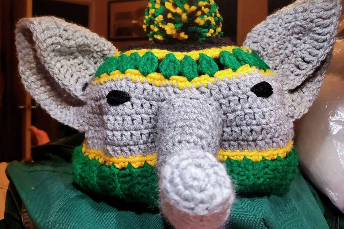 Oakland Athletics fans wear elephant hats as they cheer during the