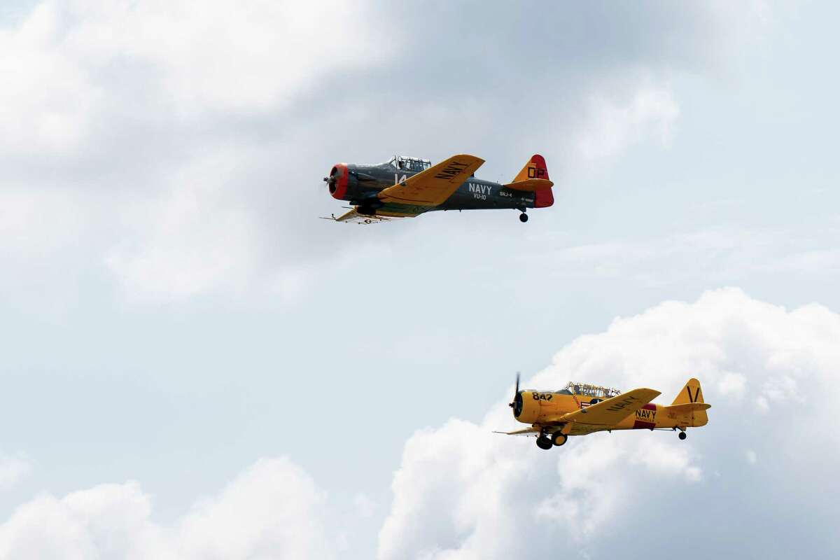 Two T-6 Texans fly over the third annual Wings & Wheels showcase to benefit the Prescott Foundation, which restores and maintains WWII aircraft and vehicles, at the Hangar at 743, on Saturday in Colonie.