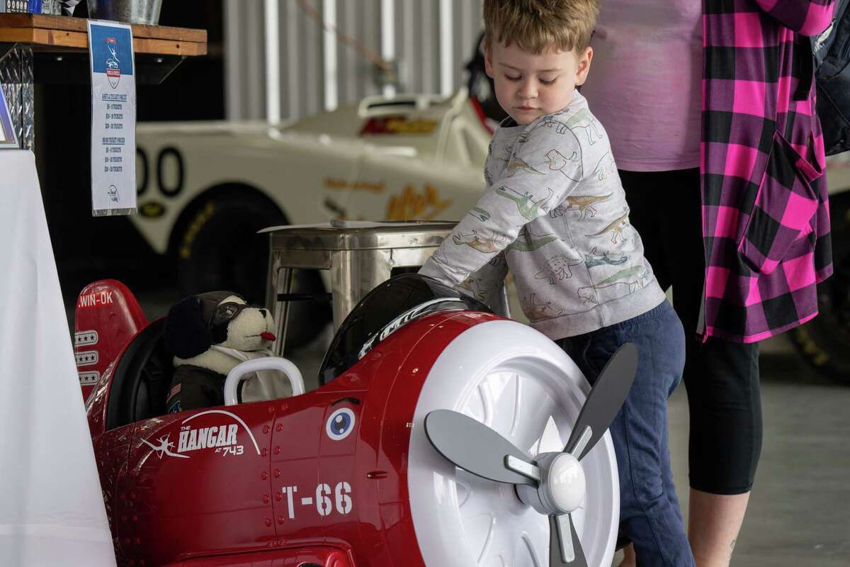 Isaiah Mahony plays with a toy plane during the third annual Wings & Wheels showcase to benefit the Prescott Foundation, which restores and maintains WWII aircraft and vehicles, at the Hangar at 743, on Saturday in Colonie.