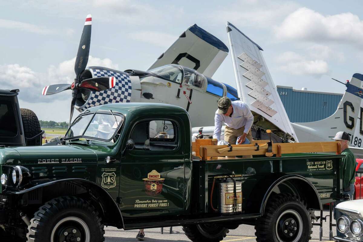 Jerry Mattison readies his 1956 Dodge power wagon, that he retrofitted to be a Vermont forest fire truck, during the third annual Wings & Wheels showcase to benefit the Prescott Foundation, which restores and maintains WWII aircraft and vehicles, at the Hangar at 743, on Saturday in Colonie.