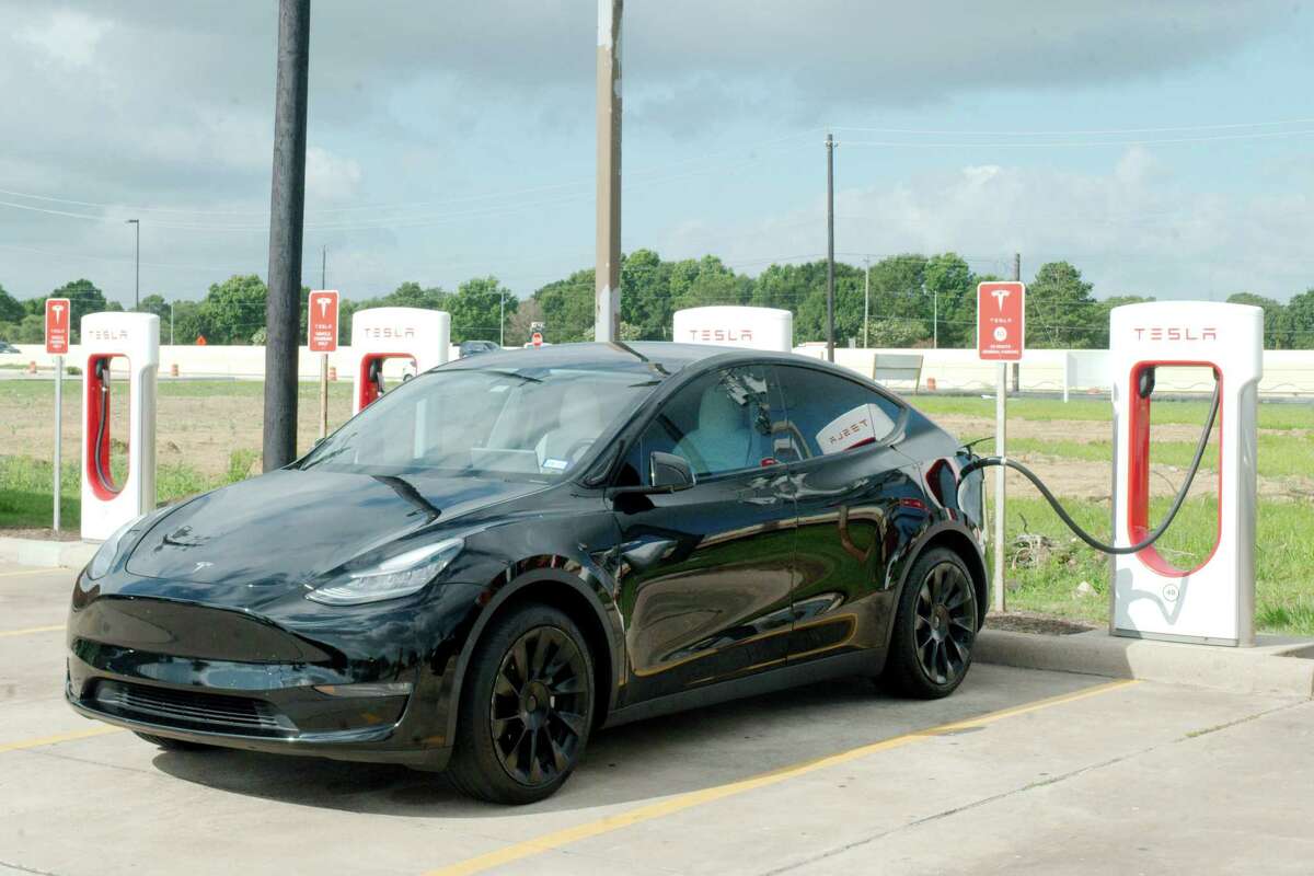 A Tesla vehicle is charged at a Tesla charging station at Rudy's Country Store and Bar-B-Q on I45 Gulf Freeway in Webster Tuesday, June 13, 2023.