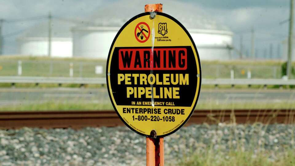 A sign warns of a buried petroleum pipeline running along Highway 3 near FM 528 in Webster Tuesday, June 13, 2023.