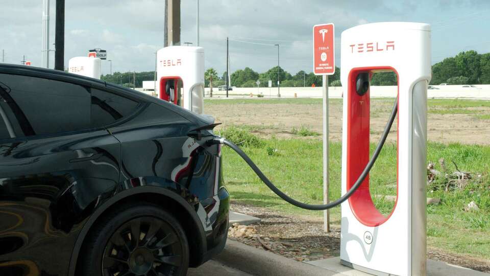 A Tesla vehicle is charged at a Tesla charging station at Rudy's Country Store and Bar-B-Q on I45 Gulf Freeway in Webster Tuesday, June 13, 2023.