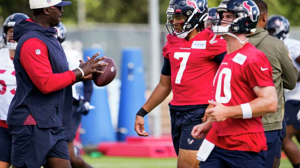 Houston Texans quarterbacks coach Jerrod Johnson works with Houston Texans quarterbacks C.J. Stroud (7) and Davis Mills (10) during mandatory mini camp on Tuesday, June 13, 2023, at Houston Methodist Training Center in Houston.