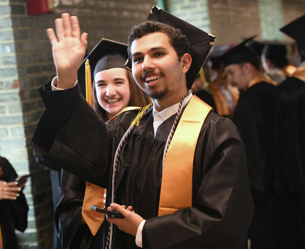 Graduating senior Ziyad Abbach waves to family during the Class of 2023 Commencement Ceremony at Academy of Information Technology & Engineering (AITE) in Stamford, Conn. Tuesday, June 13, 2023.