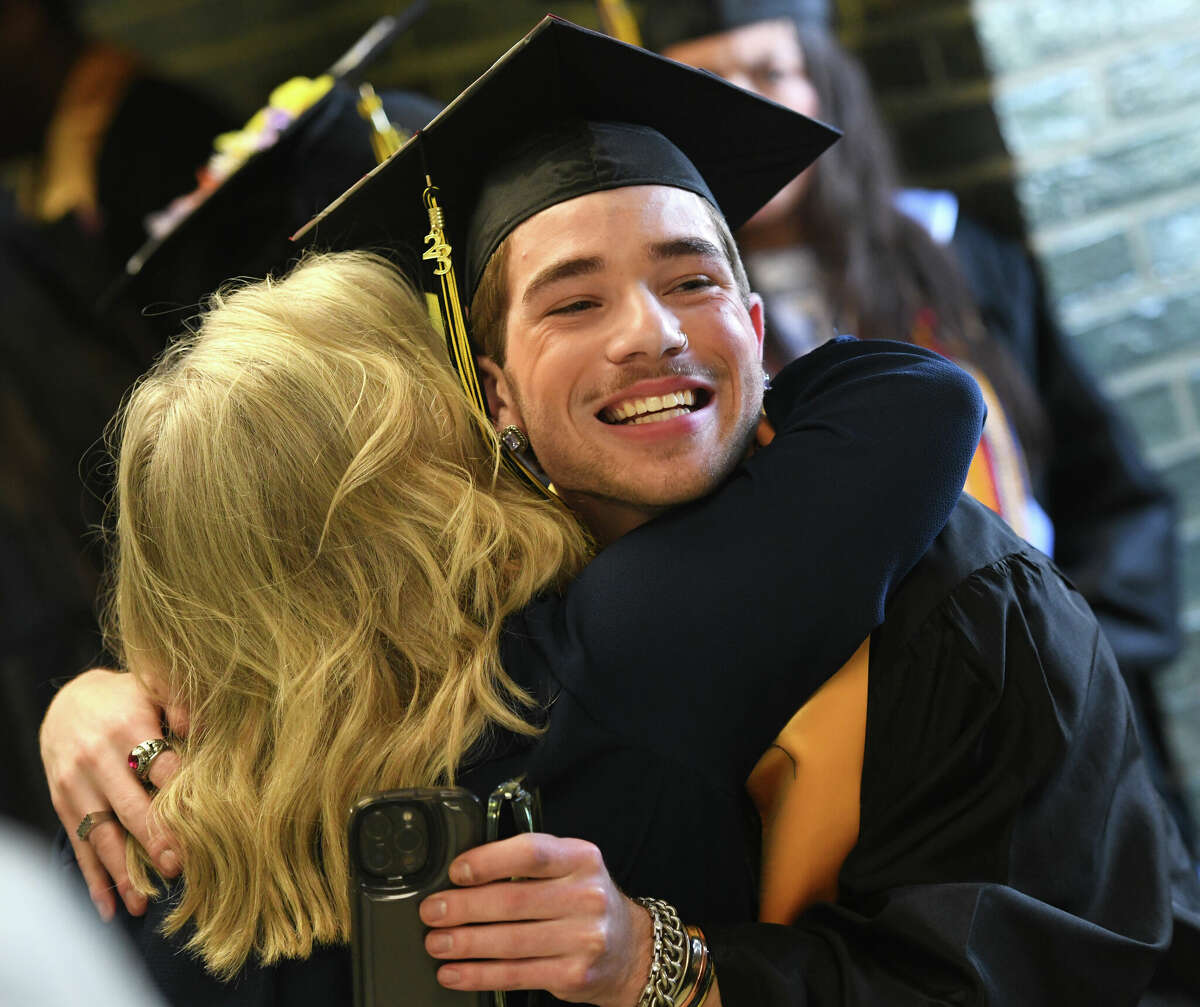 Graduating senior Rocco Lucia shares a hug during the Class of 2023 Commencement Ceremony at Academy of Information Technology & Engineering (AITE) in Stamford, Conn. Tuesday, June 13, 2023.