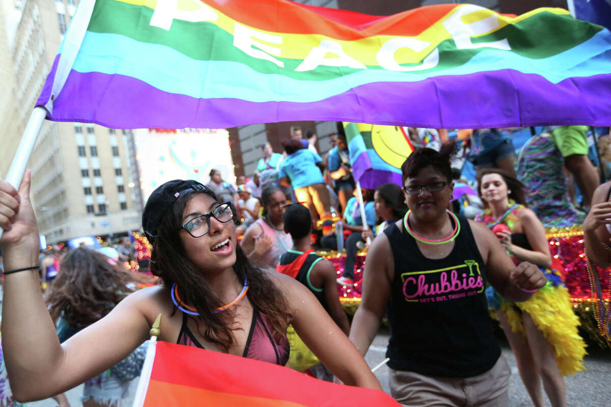 Jackie Delgado dances in the street by the Pride Houston float at the 2015 Houston Pride parade Saturday, June 27, 2015, in Houston. 'I'm here to celebrate love,' she said. ( Jon Shapley / Houston Chronicle )