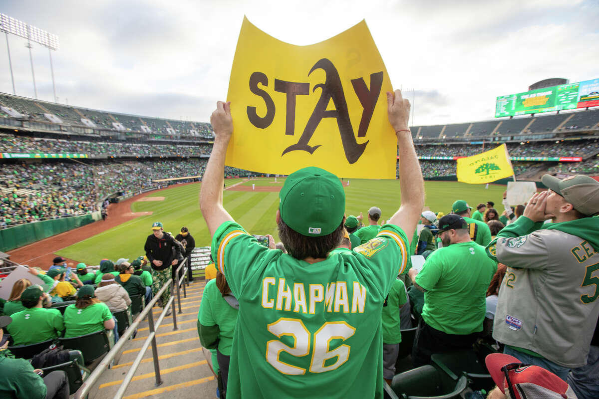 A fan holds a sign during a reverse boycott game at Oakland Coliseum in Oakland, Calif., on June 13, 2023. Athletics fans were protesting the proposed move of the team to Las Vegas by current ownership.