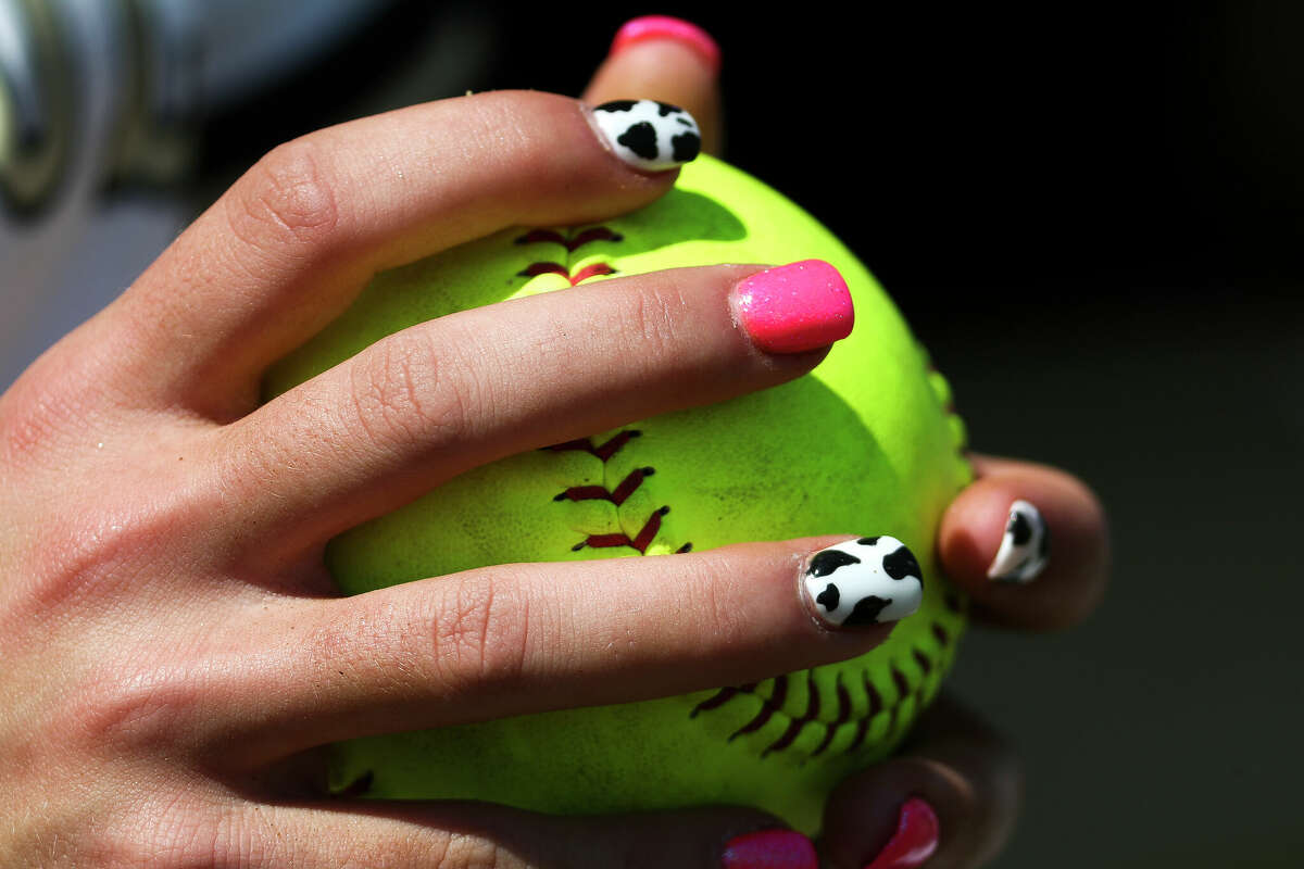 The painted fingernails of Conroe’s Kylee Davis are seen before a District 13-6A high school softball game at Conroe High School, Wednesday, March 15, 2023, in Conroe.