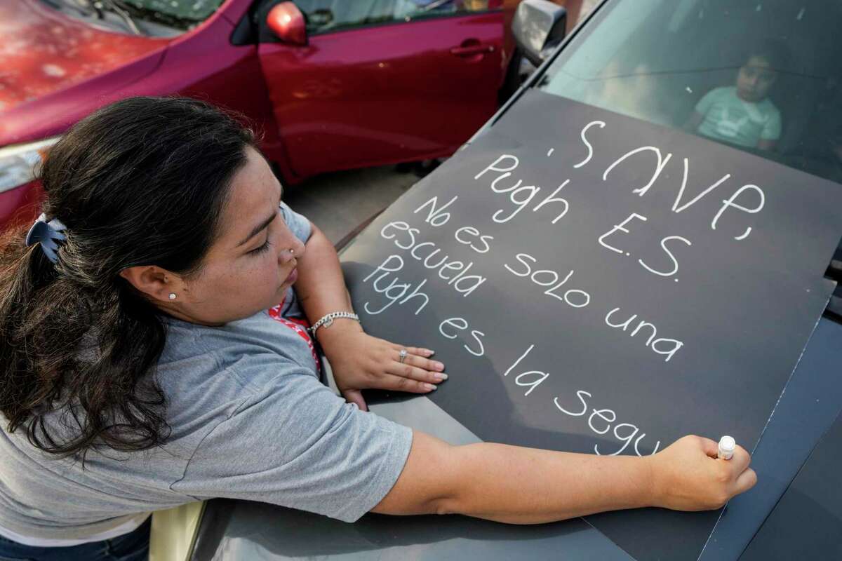 Nallely Garza make a sign as she joins parents, students and community activists near Pugh Elementary School to protest the potential replacement of their children’s teachers by HISD on Thursday, June 15, 2023 in Houston.