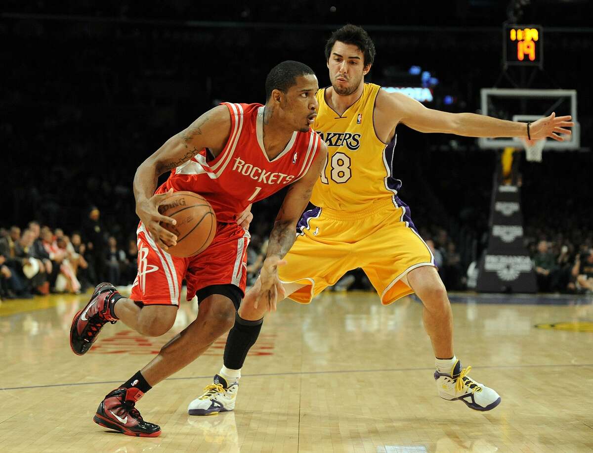 Trevor Ariza #1 of the Houston Rockets dribbles around Sasha Vujacic #18 of the Los Angeles Lakers during the game at Staples Center on January 5, 2010 in Los Angeles, California.
