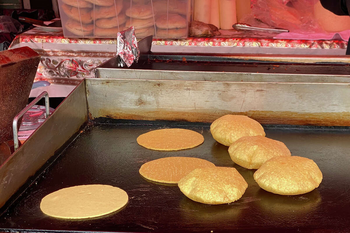 Fresh tortillas puff up on the plancha at La Parilla Loca in Oakland.