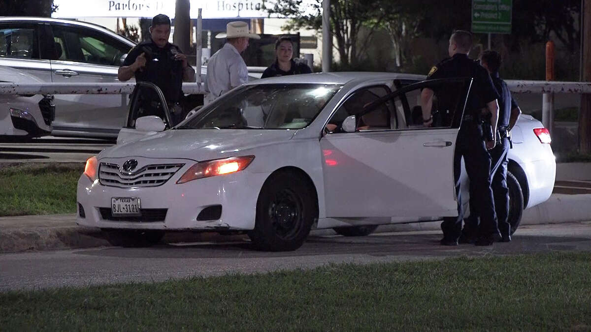 San Antonio police examine the scene of a shooting Saturday night in the 8300 block of Bandera Road. Darwin Gomez, 26, was arrested on a charge of aggravated assault with a deadly weapon in connection with the shooting.