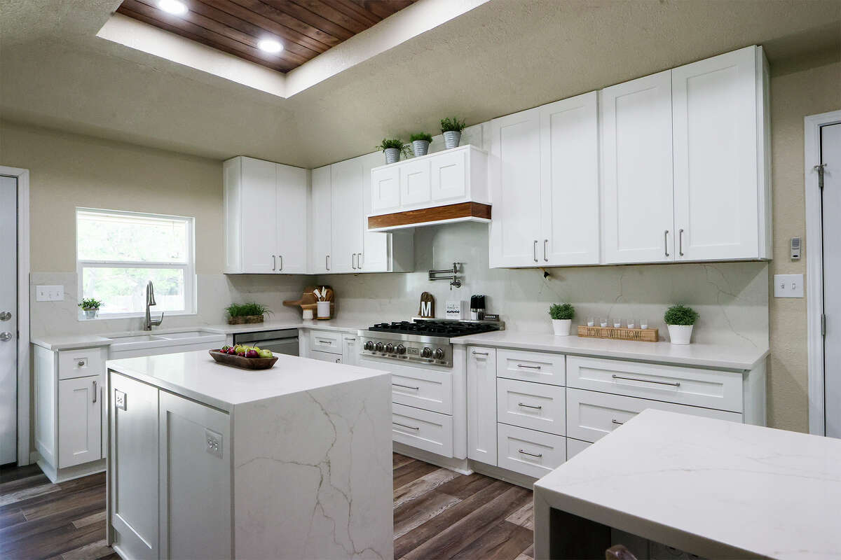 The kitchen renovation at the home of Michelle and Rick Morales in Helotes includes new cabinets, island, breakfast bar, appliances and a recessed ceiling with wood detail.