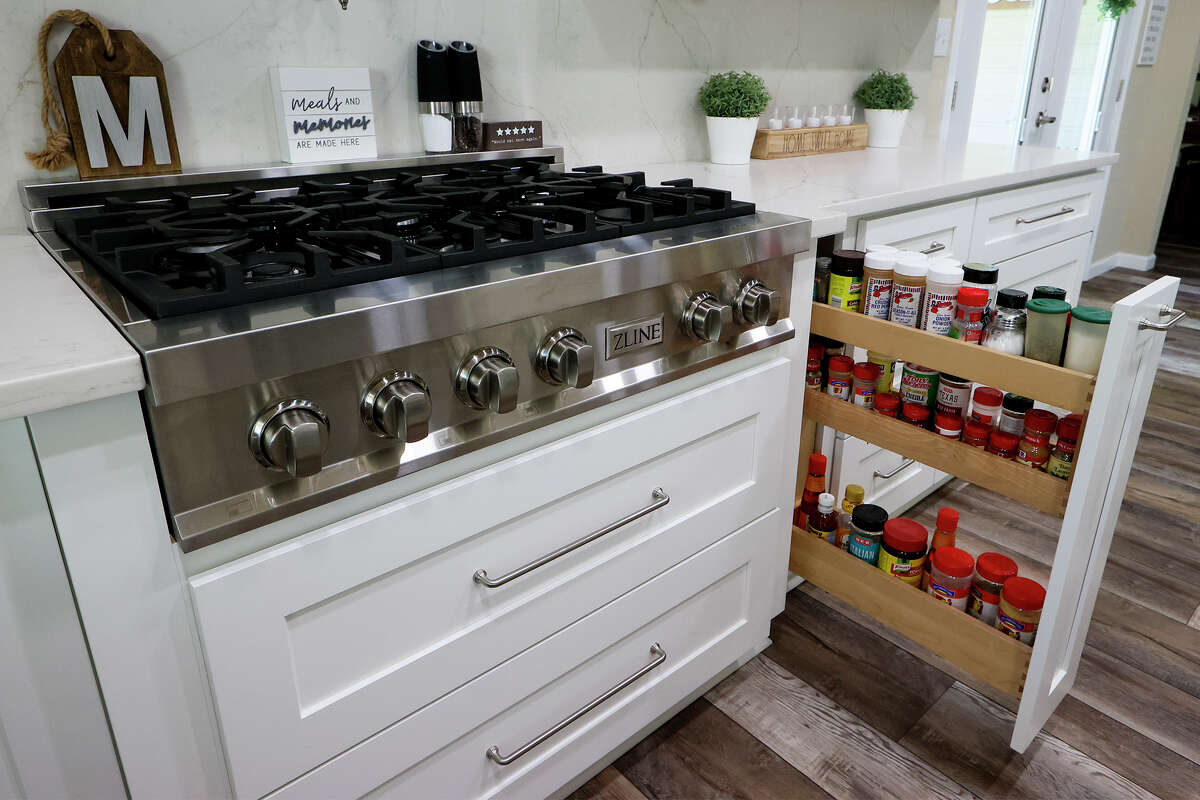A pull-out spice rack sits nets to the new gas range.