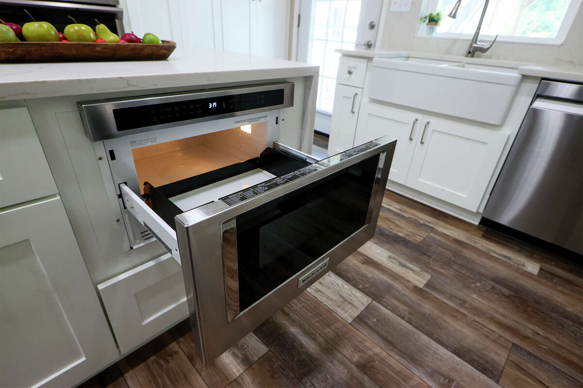 The quartz countertop island hides a microwave drawer, a popular new kitchen feature.