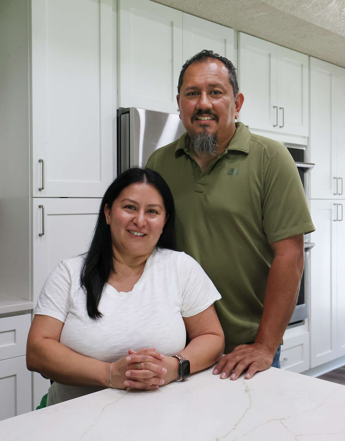 Homeowners Michelle and Rick Morales stand in their newly renovated kitchen.