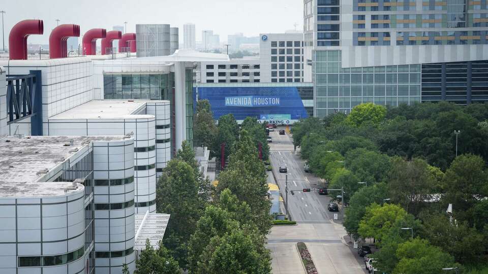 Avenida de las Americas, next to Discovery Green at right, the George R. Brown Convention Center at left, and the Hilton hotel at rear right, photographed Wednesday, June 21, 2023, in downtown Houston.