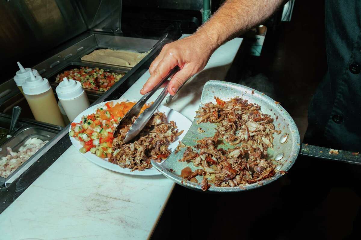 Chef Hezi Gera prepares a turkey shawarma plate at Shawowrma, an Israeli restaurant in San Jose, Calif on June 18.