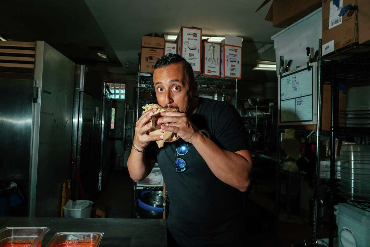 Owner Shlomo Akeri eats pita at Shawowrma, an Israeli restaurant in San Jose, Calif on June 18.
