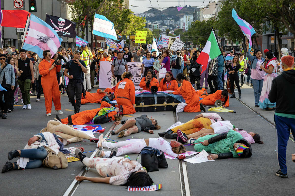 Participants of the Trans March stage a die-in on Market Street, in San Francisco on Friday, June 23.