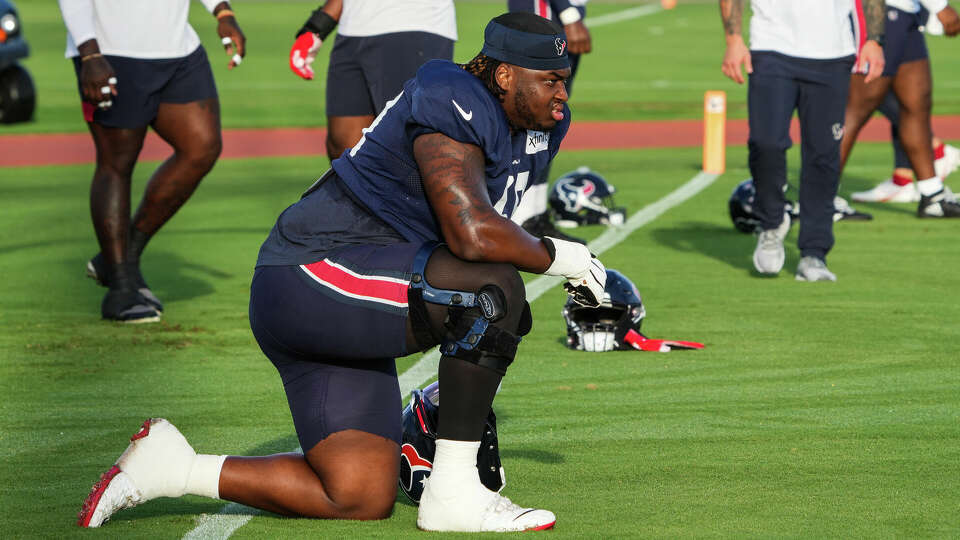 Houston Texans offensive lineman Kenyon Green (59) takes a knee before the start of practice during an NFL training camp Monday, Aug. 22, 2022, in Houston.