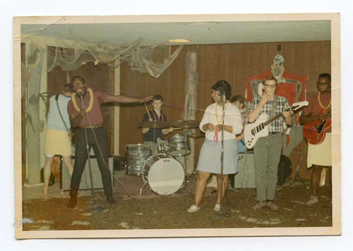 The Bluesmen, Mike Henderson’s first band, in Marshall, Mo.: John Nicholas (left, in blue); brother Ray Henderson, vocals; Billy Joe Kramer on drums; Sue, the lead singer; Galen Swift, whom Henderson taught to play guitar; and Henderson with his new red guitar.