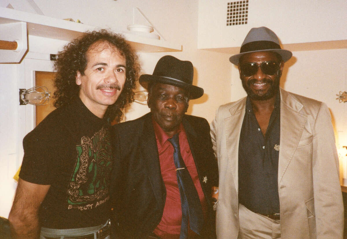 Mike Henderson (right) with Carlos Santana (left) and John Lee Hooker at the Legion of Honor in San Francisco in 1989. Henderson was the opening act for Hooker’s performance.