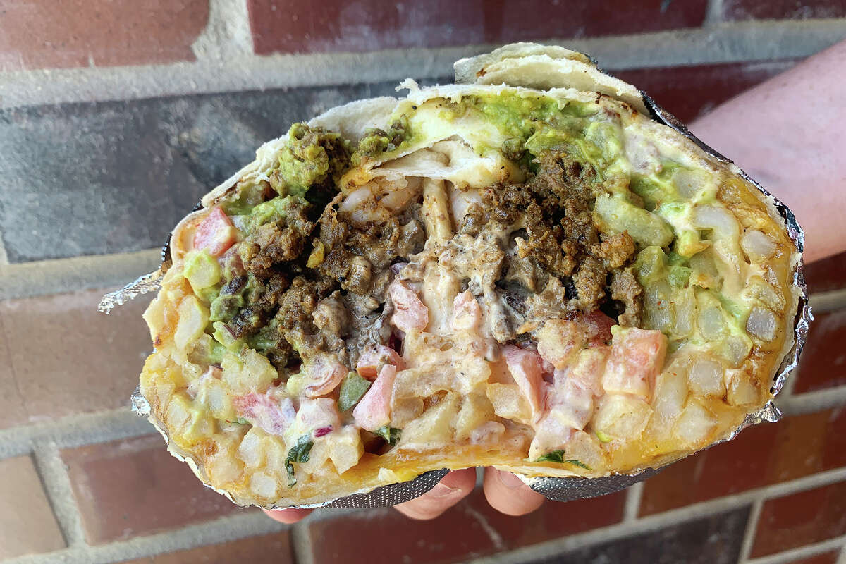The Bitchin Cali Burrito at West Coast Taco Bar features carne asada, garlic shrimp, guacamole, cheese, pico de gallo, chipotle sauce and French fries.