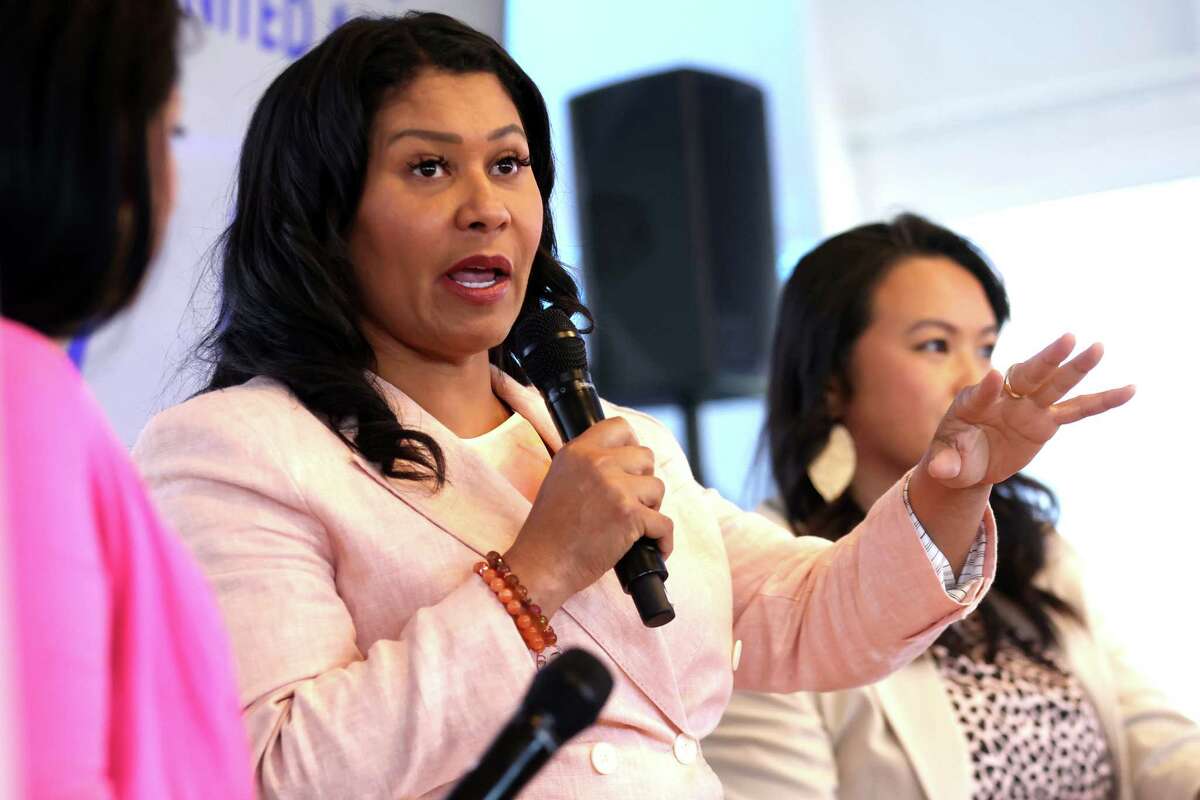 San Francisco Mayor London Breed (center) and Oakland Mayor Shen Tao (right) discuss 