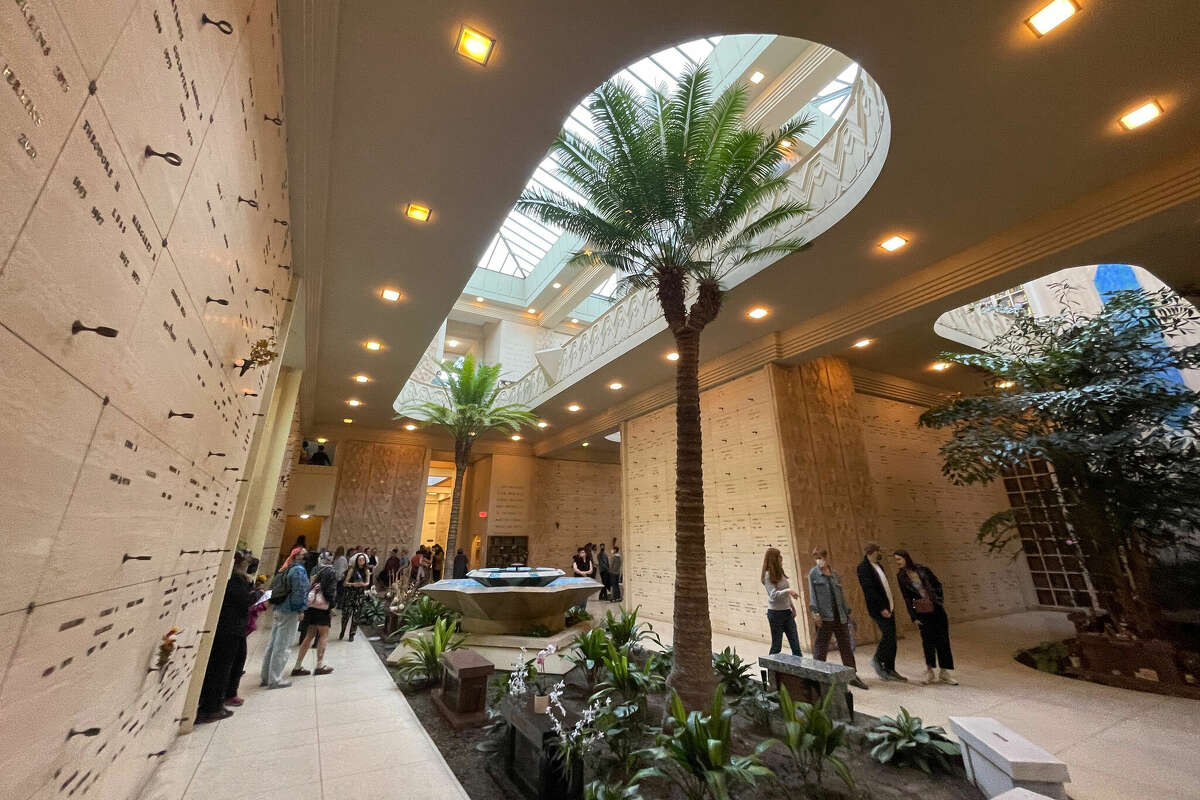 People walk through the Chapel of the Chimes Funeral Home & Crematory, in Oakland, during the Garden of Memory musical event on the summer solstice, Wednesday June 21, 2023. 