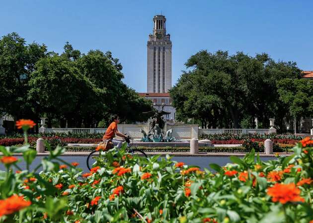 A student rides a bike towards the University of Texas at Austin campus on Wednesday, June 28, 2023 in Austin