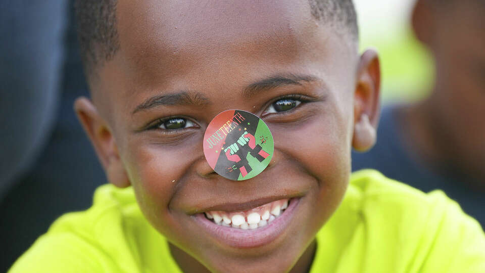 Laven Jackson, 5, smiles with a Juneteenth sticker on his nose during an unveiling event by City of Galveston of new signage that will be installed on the highway entering the Island to recognize its place as the birthplace of Juneteenth, Friday, June 16, 2023 in Galveston, Texas. (Elizabeth Conley/Houston Chronicle via AP)