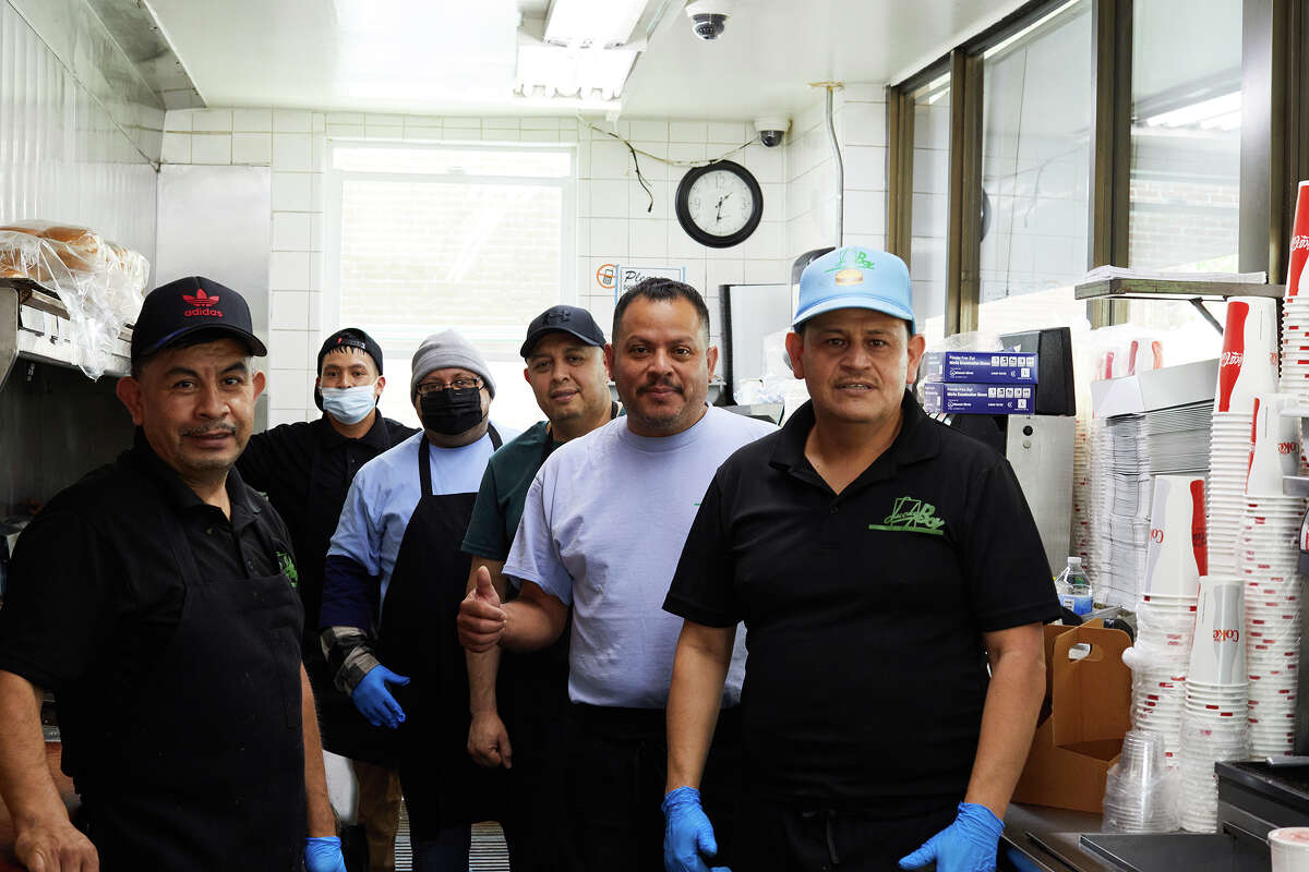 Guadalupe Cano, right, stands with kitchen staff at Lucky Boy in Pasadena, Calif., on Thursday. Cano has worked for the restaurant for 40 years.