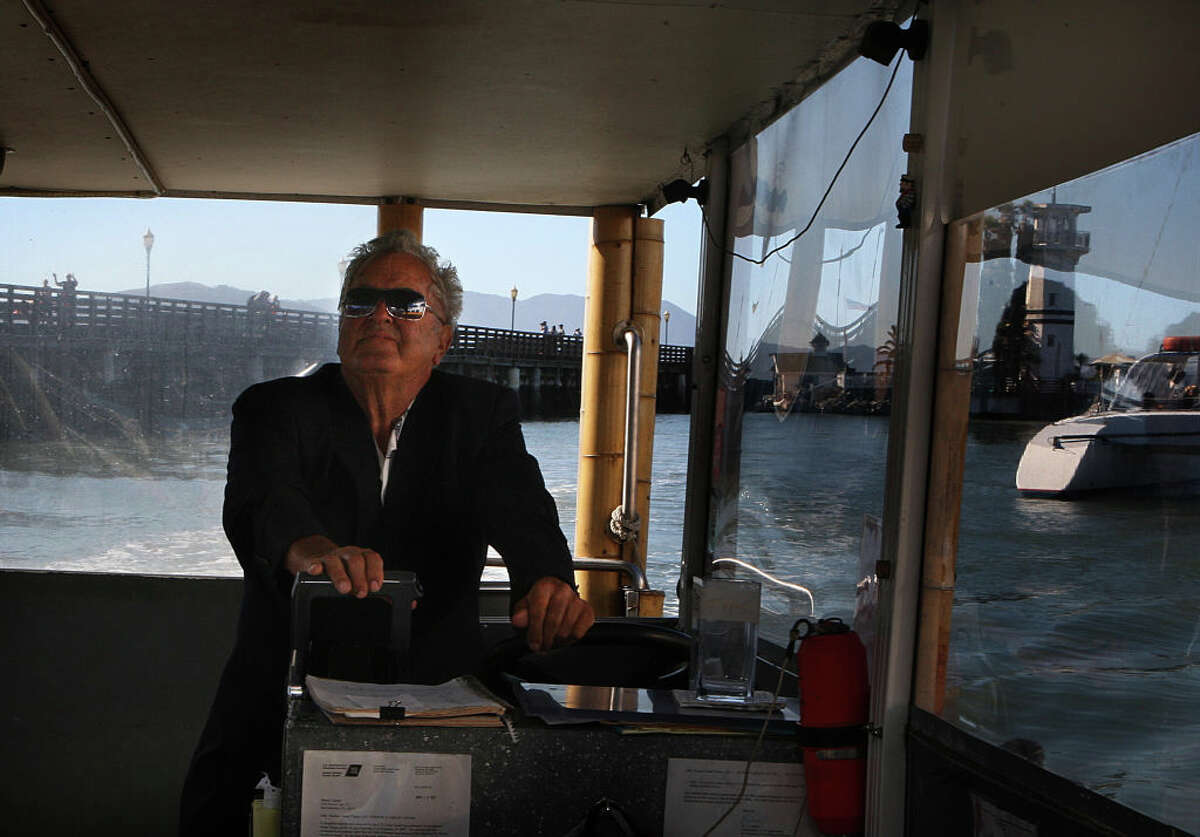 Forbes Thor Kiddoo rides his boat to shore from Forbes Island in San Francisco on Thursday, Sept. 5, 2013.