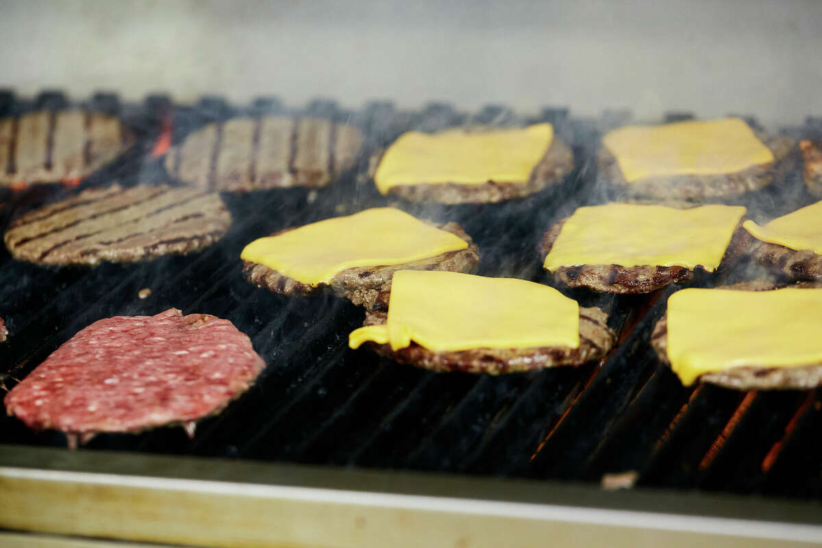 Burgers cook on the grill at Lucky Boy in Pasadena. 