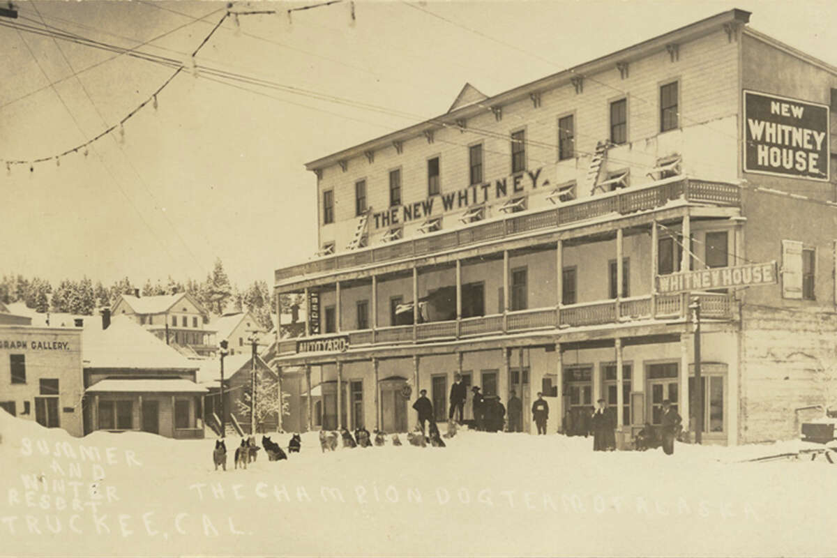 View of the New Whitney House hotel in Truckee, Nevada County. A dog team is seen in the snow in front of hotel building in Truckee Calif.,  Between 1904 and 1918.