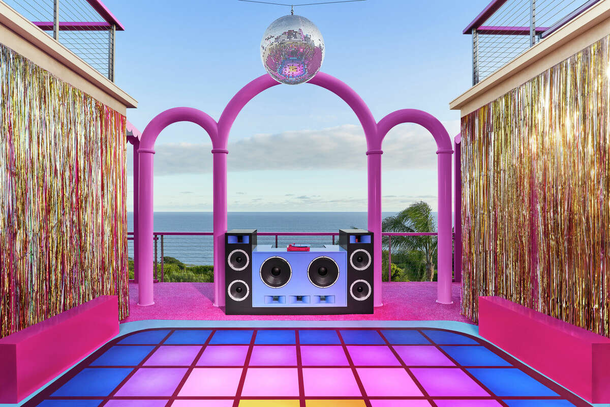 The dance floor, complete with a suspended disco ball, is shown at the Barbie Dreamhouse in Malibu, Calif. on Airbnb. But, in a cruel twist, the property has a "strict no-party policy."