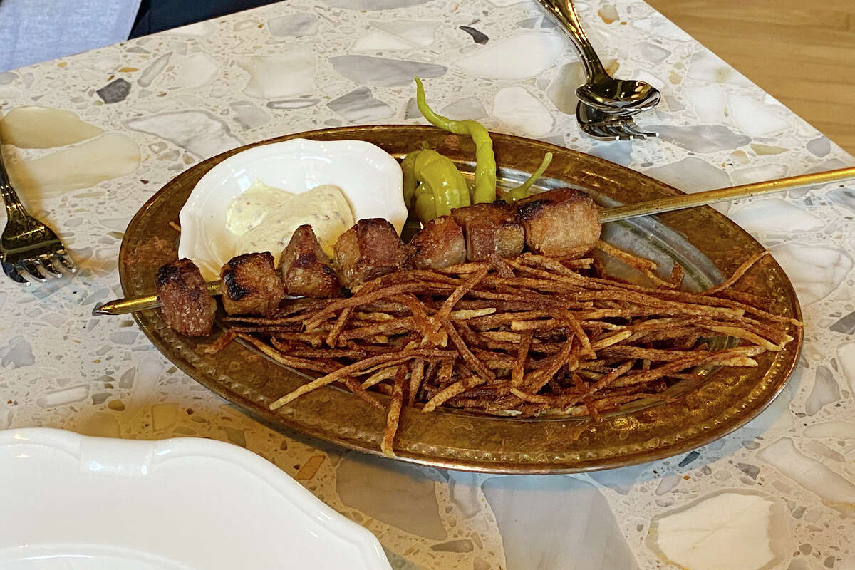 Ibérico pork souvlaki over crispy potatoes at Dalida in San Francisco.