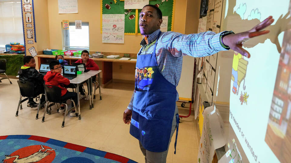 Second grade teacher Brayleon Thorns works on a reading lesson with his students at Highland Heights Elementary on Tuesday, April 11, 2023 in Houston.