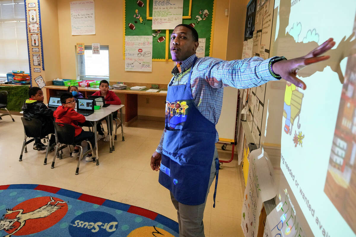 Second grade teacher Brayleon Thorns works on a reading lesson with his students at Highland Heights Elementary on Tuesday, April 11, 2023 in Houston.