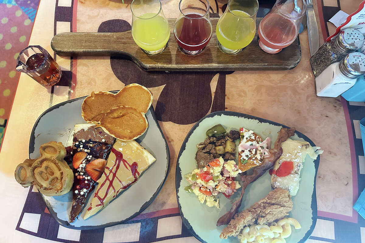 Round 1 of breakfast: a Mickey waffle, a Mickey pancake and sweets like Nutella pizza on the left; vegan scramble, scrambled eggs and savory foods on the right. 