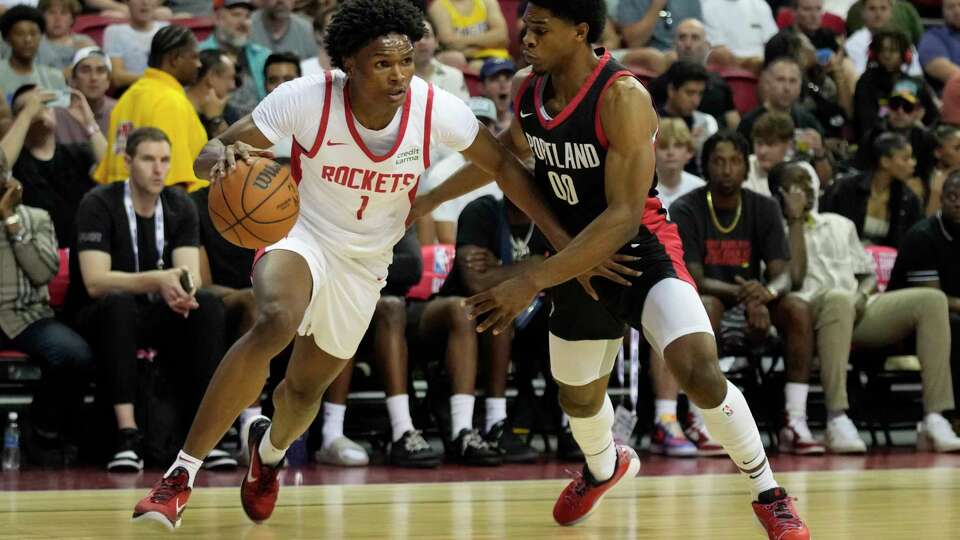 Houston Rockets' Amen Thompson drives against Portland Trail Blazers' Scoot Henderson during the first half of an NBA summer league basketball game Friday, July 7, 2023, in Las Vegas. (AP Photo/John Locher)