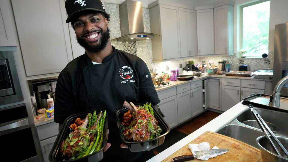 Personal chef Devown Hines show off a lamb dish he prepared to deliver to a client on Friday, July 7, 2023 in Houston. Hines' Flavaz Personal Chef and Catering makes special meals for a variety of clients, including professional athletes.